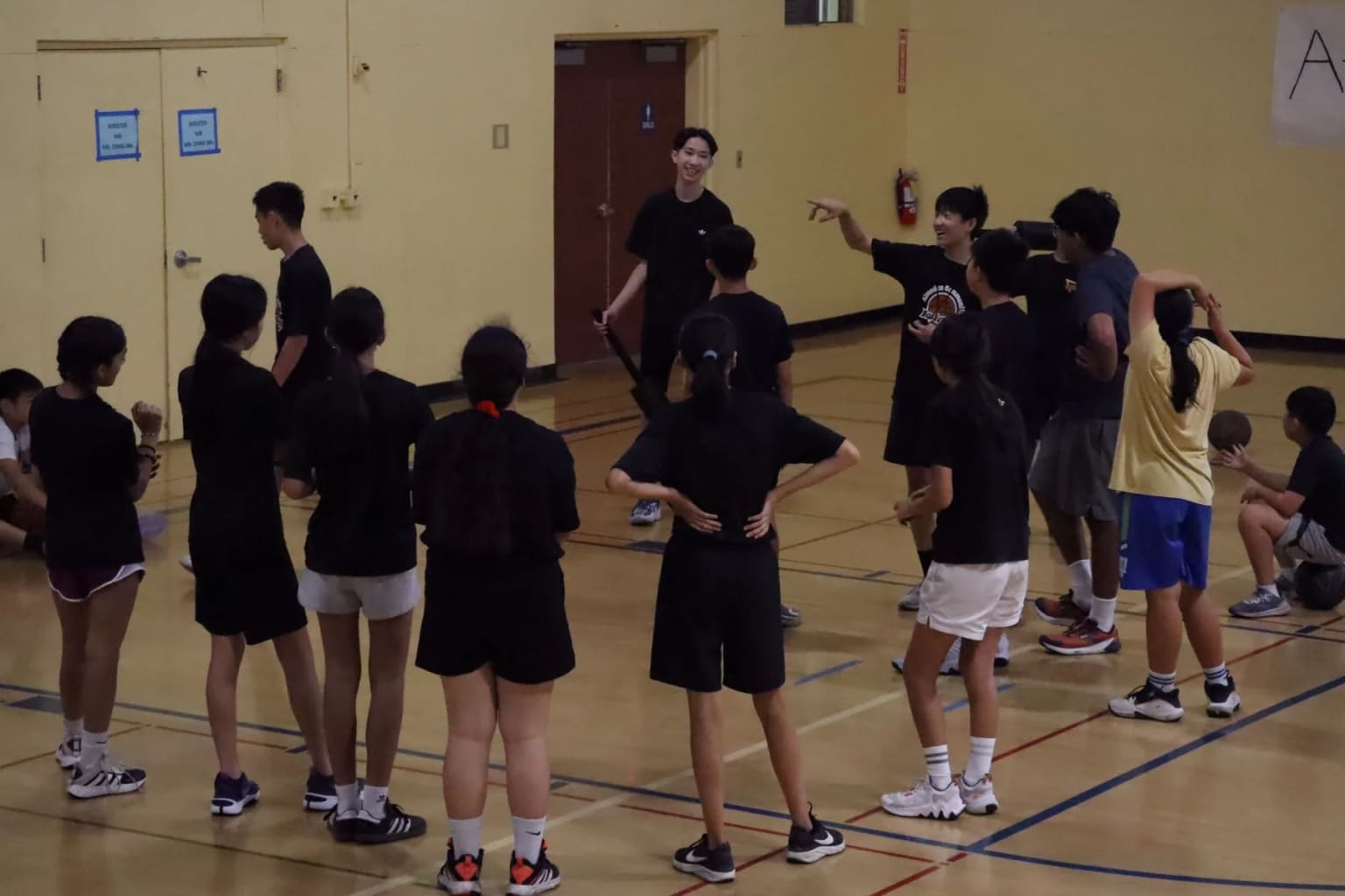 Student coaches leading an ACB group in the gym.