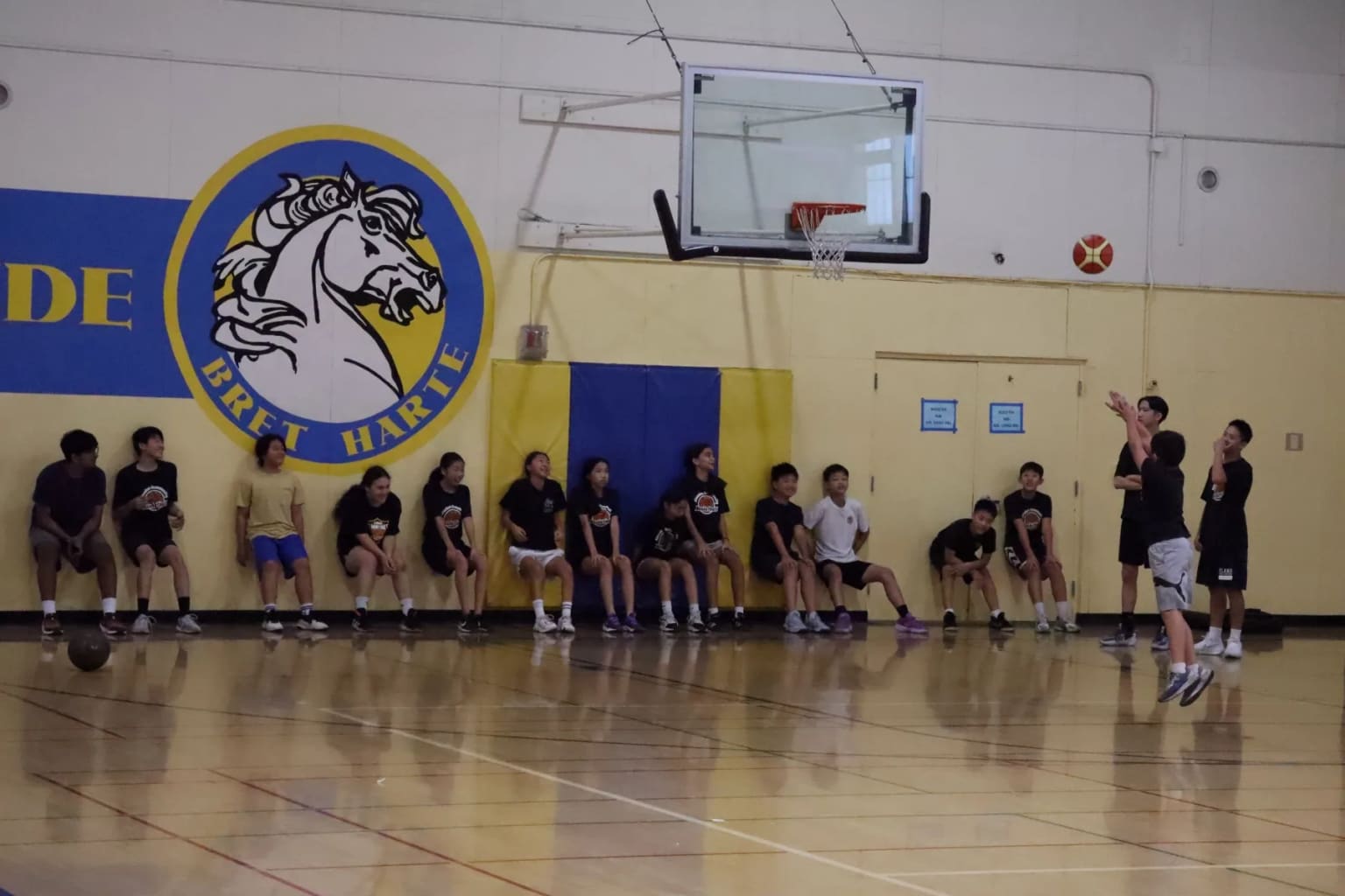 A player taking a free throw in front of spectators.
